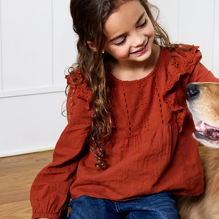 A girl sitting on the floor with a dog