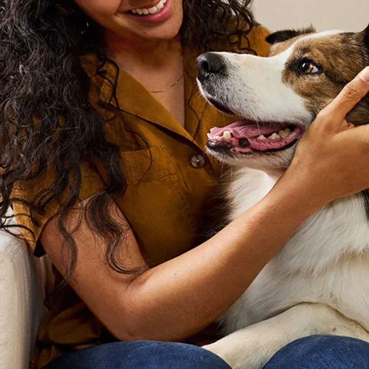 A woman holding a dog