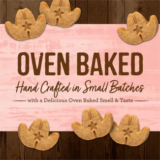 Oven Baked Cowboy Cookout leaf-shaped dog treats on a pink background that says “Oven baked hand crafted in small batches with a delicious oven baked smell &amp; taste.” 